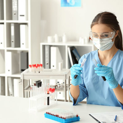 Woman in lab working with test tubes